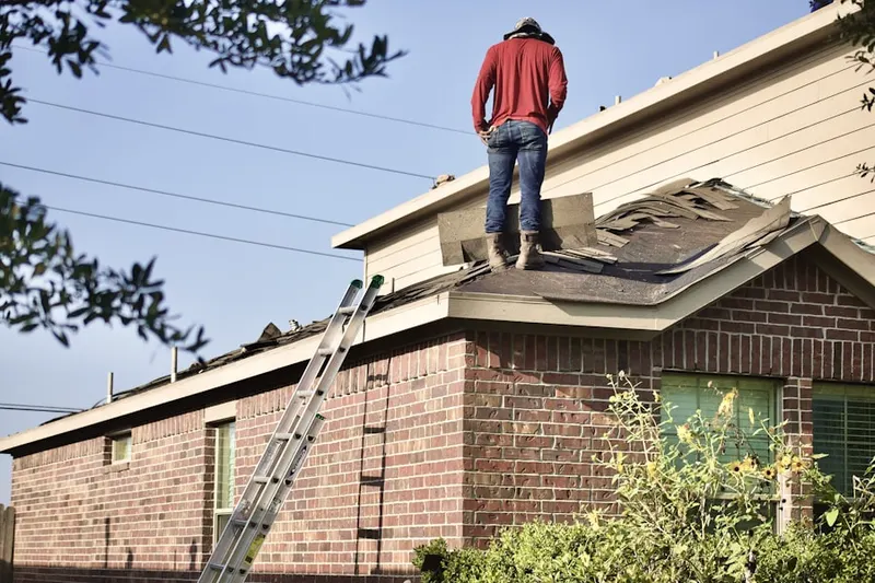 Professional roofer working on a residential roof in Maidu